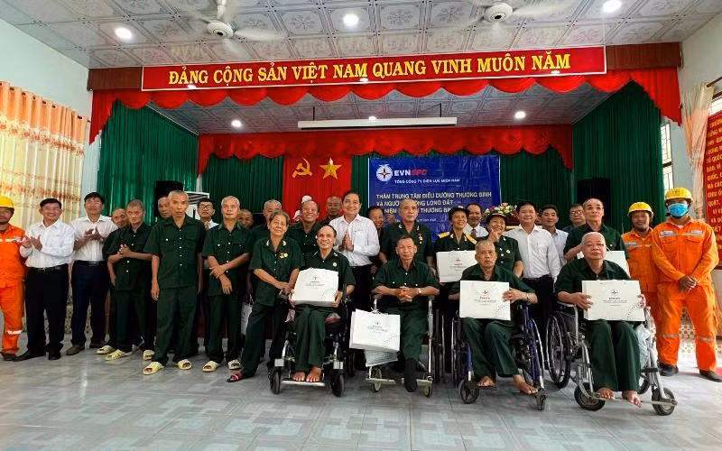 Đoàn công tác của EVN SPC chụp hình lưu niệm cùng các thương, bệnh binh tại Trung tâm điều dưỡng thương binh và người có công Long Đất.