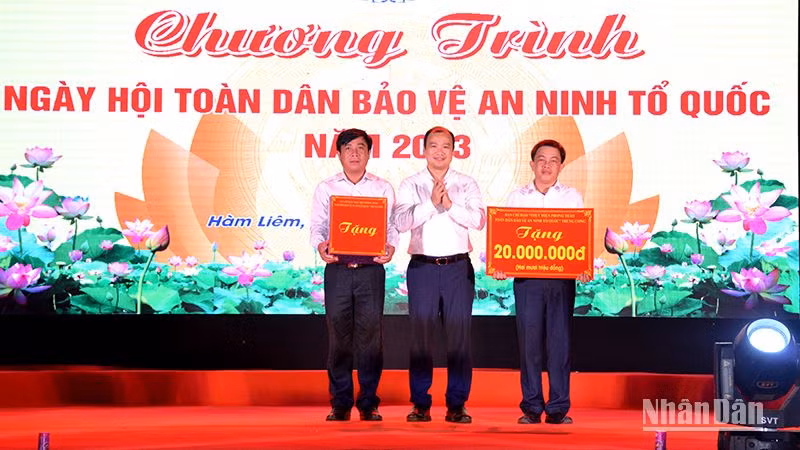 Đồng chí Lê Hải Bình, thay mặt Ban chỉ đạo Trung ương tặng quà cho nhân dân và cán bộ xã Hàm Liêm, huyện Hàm Thuận Bắc. (Ảnh: Đình Châu)