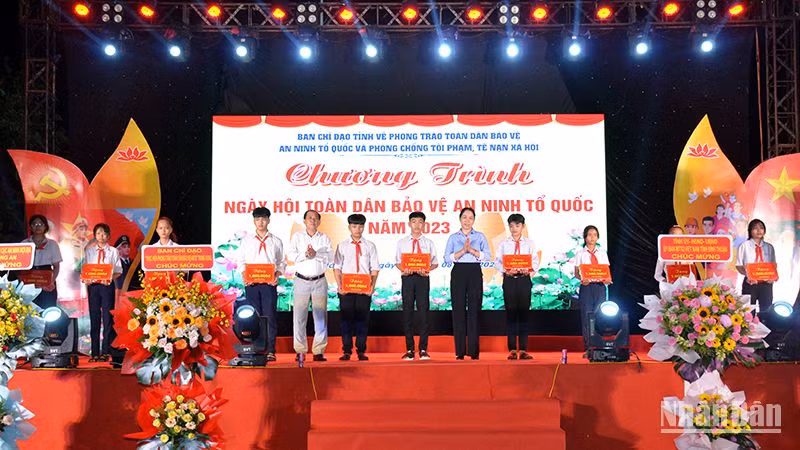 Đại diện Ban chỉ đạo tỉnh Bình Thuận và huyện Hàm Thuận Bắc trao quà cho học sinh vượt khó ở xã Hàm Liêm. (Ảnh: Đình Châu)