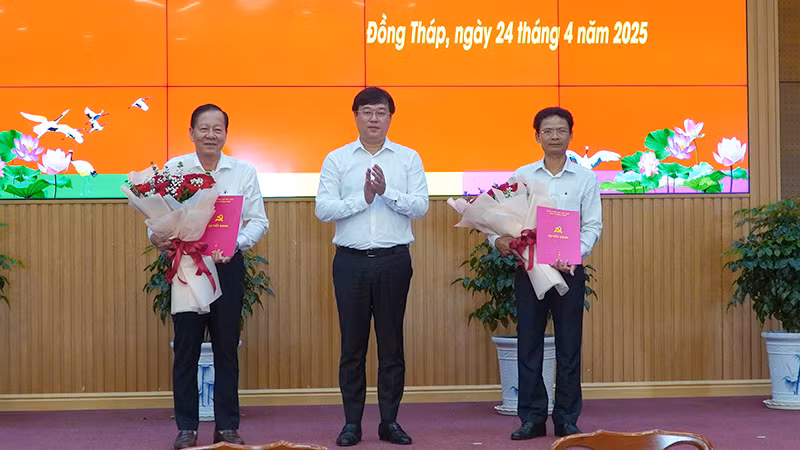 Bí thư Tỉnh ủy Đồng Tháp Lê Quốc Phong trao quyết định và tặng hoa chúc mừng 2 đồng chí Phan Văn Hợp và Bùi Thanh Tiền. (Ảnh: HỮU NGHĨA).