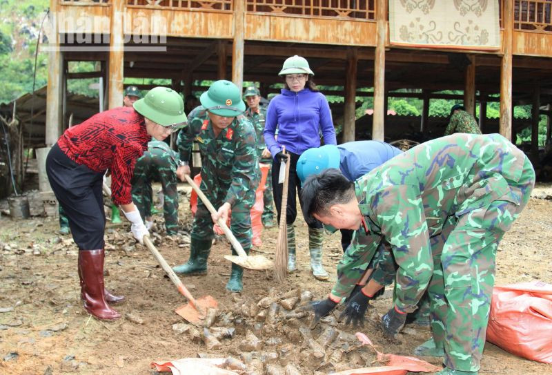 Lãnh đạo Thành ủy Sơn La cùng các lực lượng tham gia giúp các hộ dân bản Phiêng Nghè thu gom rác, vệ sinh môi trường sau khi nước rút.