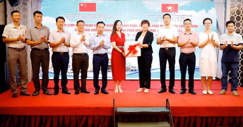 Lãnh đạo Ủy ban nhân dân Phường Trần Phú, Móng Cái (Việt Nam) tặng quà lưu niệm cho Đoàn công tác trấn Đông Hưng (Trung Quốc.)