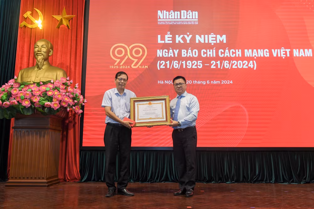 Tổng Biên tập, Bí thư Đảng ủy Báo Nhân Dân Lê Quốc Minh, thừa ủy quyền của Chủ tịch nước trao tặng Huân chương Lao Động hạng Nhì cho đồng chí Lê Mậu Lâm, Phó Trưởng Ban Xây dựng Đảng, Báo Nhân Dân. (Ảnh: THẾ ĐẠI)
