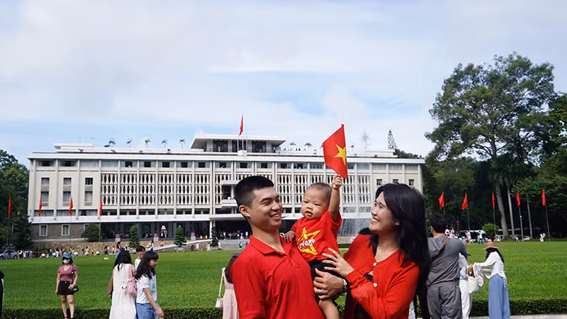 Ngay từ sáng sớm, nhiều gia đình và các bạn nhỏ cầm trên tay lá cờ tổ quốc đến Dinh Độc Lập để đón mừng ngày Quốc khánh 2/9.