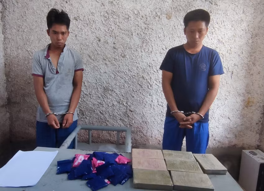 Sùng A Só (phải) cùng Sùng A Vừ và tang vật tại cơ quan công an.