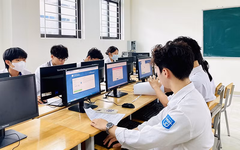 Học sinh lớp 12, Trường THPT Trương Định (Hoàng Mai, Hà Nội) thử đăng ký dự thi tốt nghiệp THPT trên hệ thống quản lý thi, sáng 24/4. (Ảnh MAI MAI)