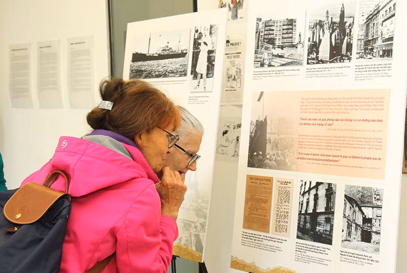 Hai bà Doãn Thị Nhài và Christine Guilleux được xem nhiều ảnh tư liệu về những nơi in dấu chân của Chủ tịch Hồ Chí Minh tại Pháp. (Ảnh: Minh Duy)
