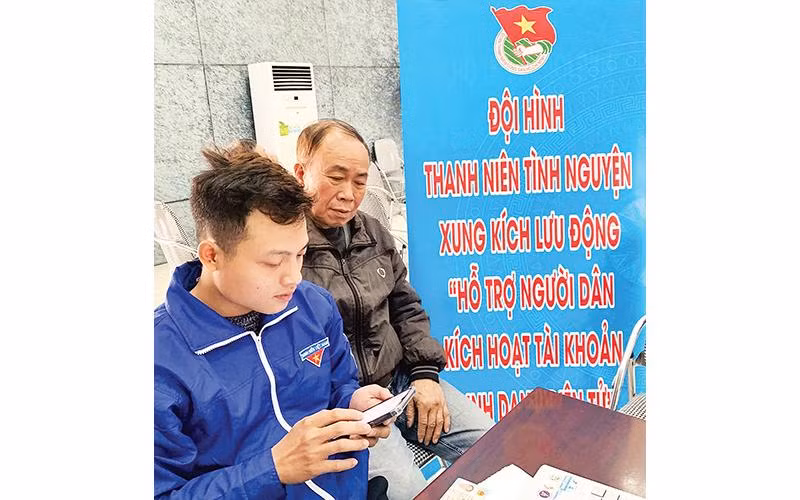 Thanh niên quận Hoàng Mai hỗ trợ người dân kích hoạt tài khoản định danh điện tử. 