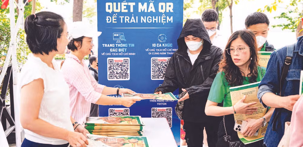 Cán bộ, phóng viên Báo Nhân Dân trao tặng phụ san đặc biệt cho độc giả.