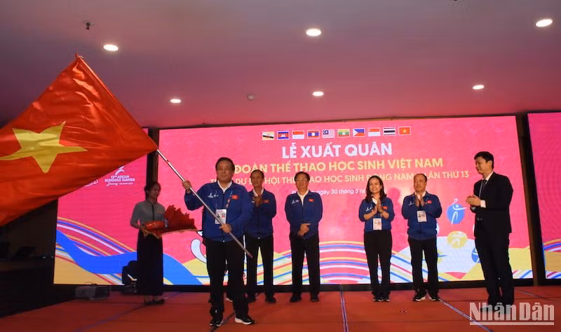 Vụ trưởng Vụ Giáo dục-Thể chất Nguyễn Thanh Đề trao Cờ Tổ quốc cho Trưởng đoàn Thể thao học sinh Việt Nam tham dự Đại hội. (Ảnh: ANH ĐÀO)