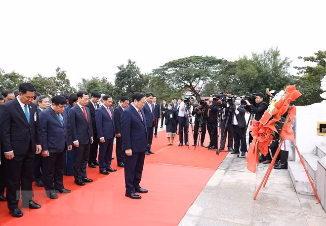 Thủ tướng Phạm Minh Chính và đoàn đại biểu cấp cao Việt Nam đặt vòng hoa tại Đài tưởng niệm chiến sĩ vô danh Lào. (Ảnh: Dương Giang/TTXVN)