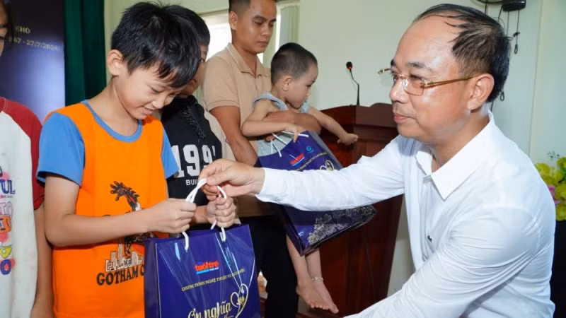 Nhà báo Nguyễn Mạnh Hưng trao quà cho các em nhỏ có hoàn cảnh khó khăn tại huyện Anh Sơn. (Ảnh: Báo Tuổi trẻ Thủ đô)