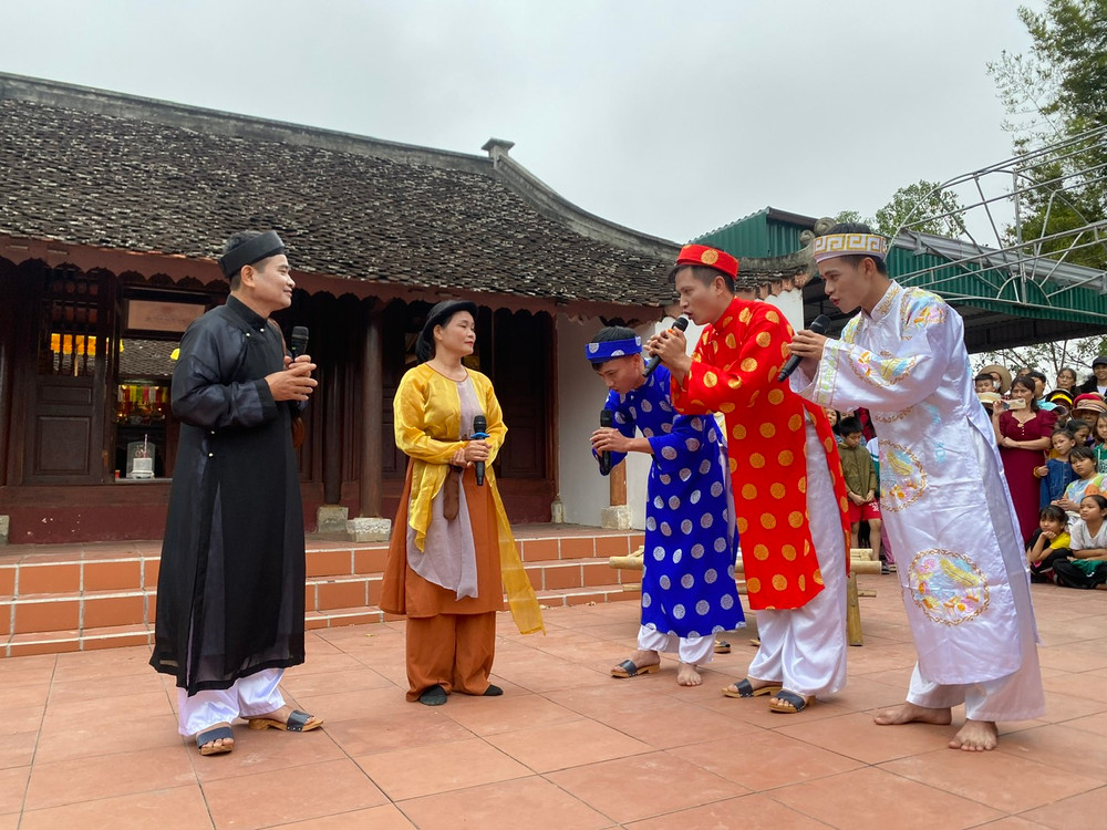 Người dân làng Quỳnh tái hiện câu chuyện “Ông đồ Nghệ và con cá gỗ”.