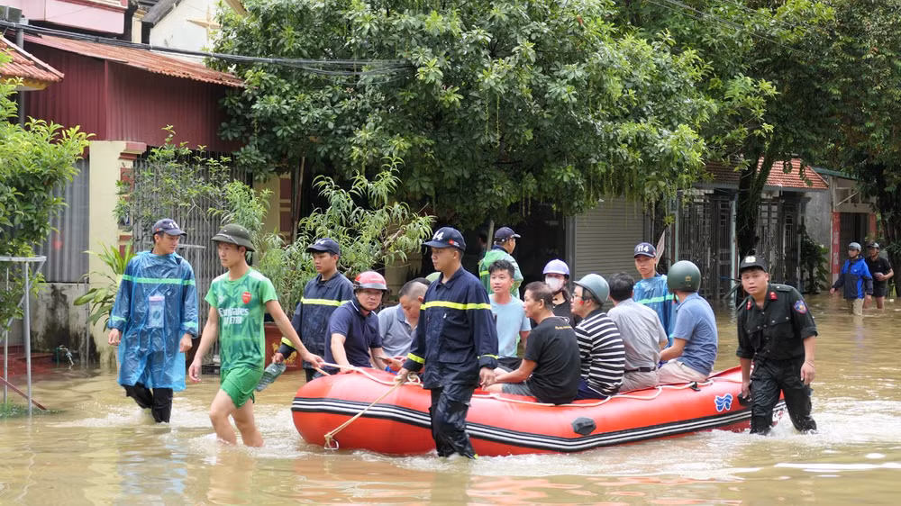 Nhiều khu vực tại thành phố Hà Giang ngập sâu trong nước, lực lượng công an hỗ trợ người dân đến nơi an toàn.