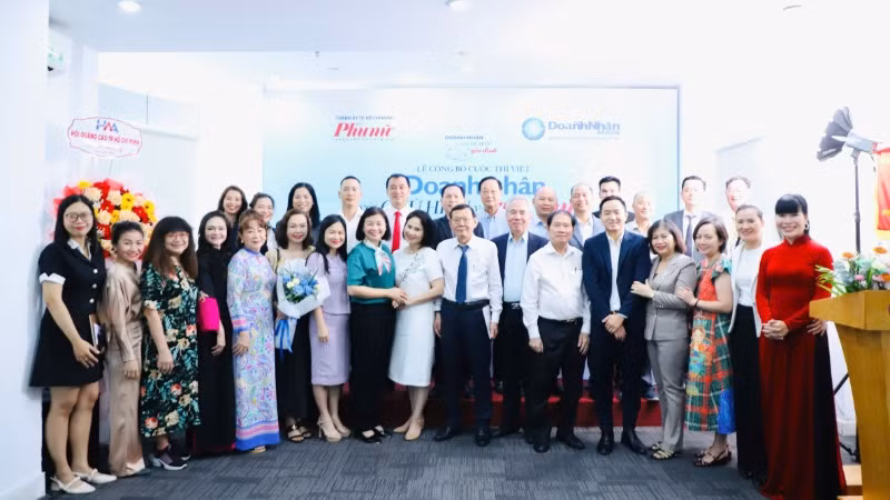 Các đại biểu tham dự lễ công bố cuộc thi chụp ảnh lưu niệm.