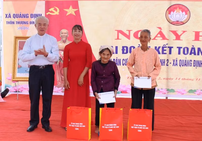 Thay mặt Trung ương Mặt trận Tổ quốc Việt Nam, linh mục Trần Xuân Mạnh tặng quà cho người dân trong thôn Thượng Đình 2, xã Quảng Định.