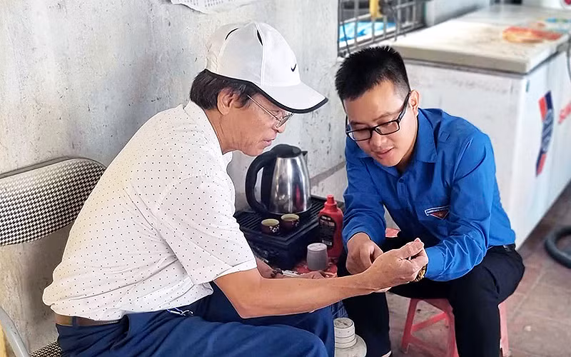 Thành viên Câu lạc bộ Hỗ trợ chuyển đổi số xã Dương Xá hướng dẫn người dân cài đặt, sử dụng các ứng dụng thông minh.