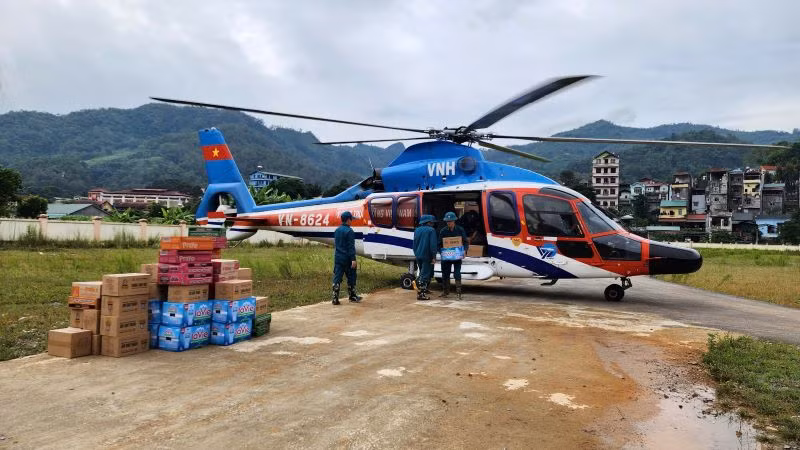 Nhu yếu phẩm chuyển từ máy bay xuống sân vận động huyện Nguyên Bình, tỉnh Cao Bằng. (Ảnh: Thông tấn quân sự cung cấp)
