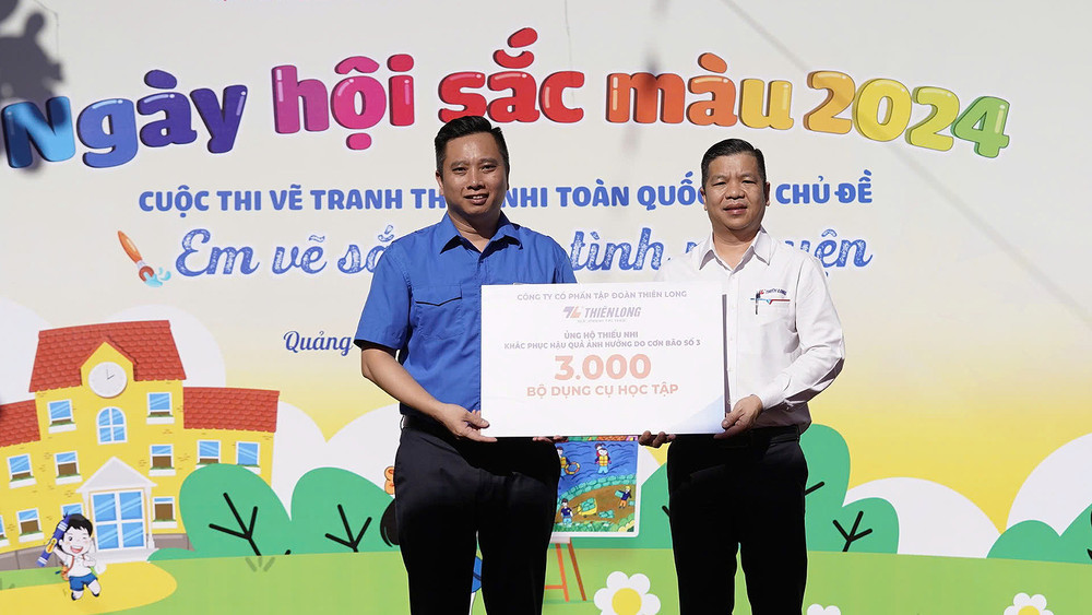 Phó Chủ tịch Hội đồng Đội Trung ương, Giám đốc Trung tâm hỗ trợ và phát triển thiếu nhi Việt Nam Lê Anh Quân tiếp nhận 3.000 bộ dụng cụ học tập từ đại diện Tập đoàn Thiên Long tại Ngày hội.