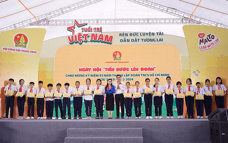 Bí thư Trung ương Đoàn, Chủ tịch Hội đồng Đội Trung ương Nguyễn Phạm Duy Trang (áo xanh) trao học bổng tặng học sinh vượt khó học tốt.