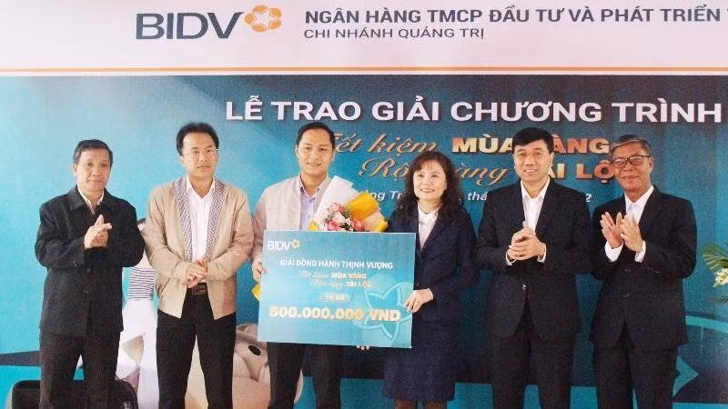 Lãnh đạo BIDV Chi nhánh Quảng Trị và lãnh đạo Ngân hàng Nhà nước Việt Nam Chi nhánh Quảng Trị trao giải thưởng cho khách hàng Lê Ngọc Phúc.