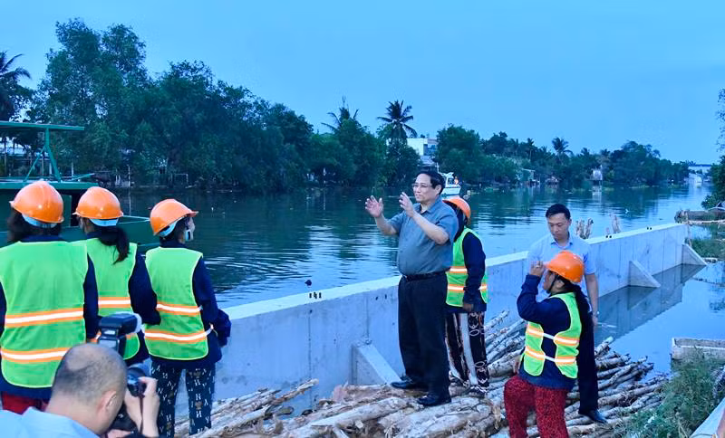Thủ tướng Phạm Minh Chính nói chuyện với công nhân đang thi công dự án kè chống sạt lở khẩn cấp sông Trà Nóc.
