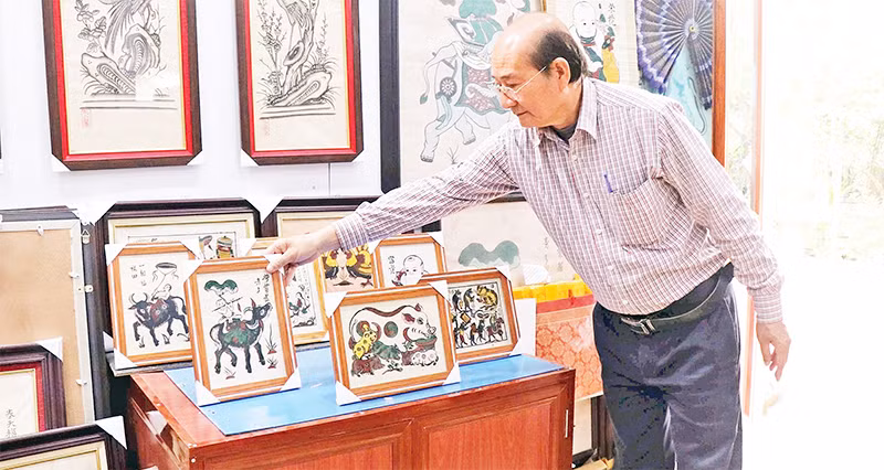 Nghệ nhân Nguyễn Hữu Hoa giới thiệu sản phẩm OCOP tranh dân gian Đông Hồ để bàn.