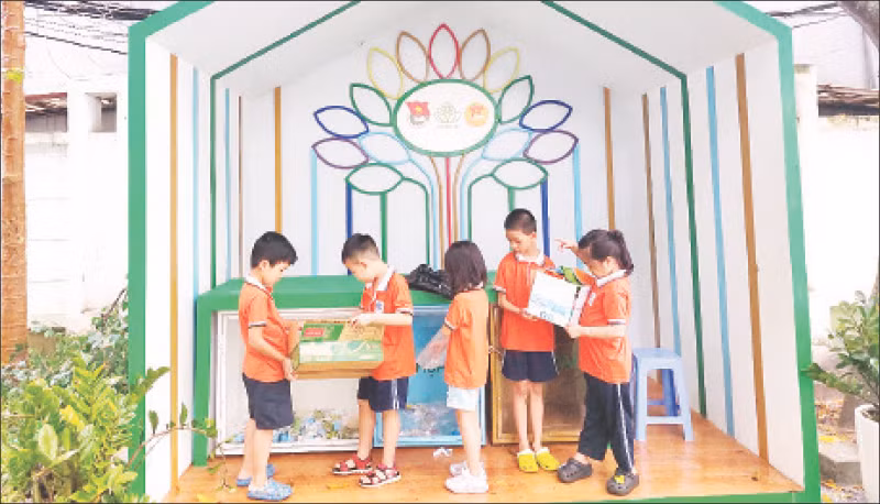 Các em học sinh thực hiện phân loại rác tái chế.