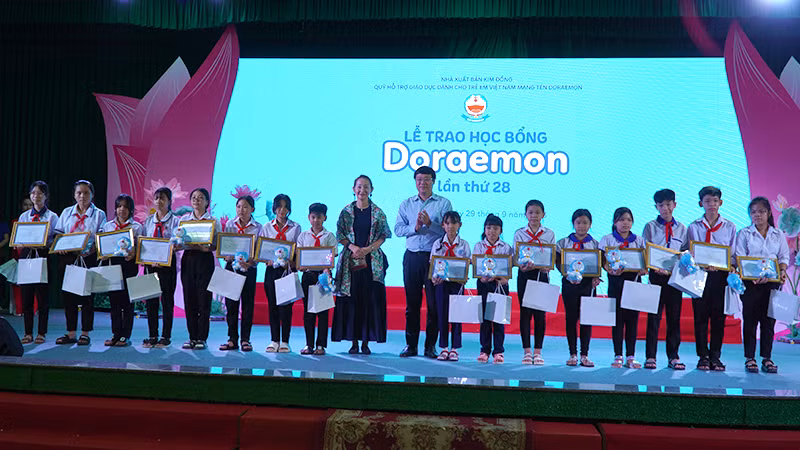 Ủy viên Trung ương Đảng, Bí thư Tỉnh ủy Đồng Tháp Lê Quốc Phong và bà Katsumata Jitsuko - Tổng Giám đốc điều hành Công ty Fujiko Production trao học bổng cho học sinh. (Ảnh: HỮU NGHĨA)