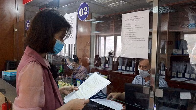 Doanh nghiệp làm thủ tục đăng ký kinh doanh tại Bộ phận một cửa Sở Kế hoạch và Đầu tư Hà Nội. (Ảnh: Mạnh Khánh)