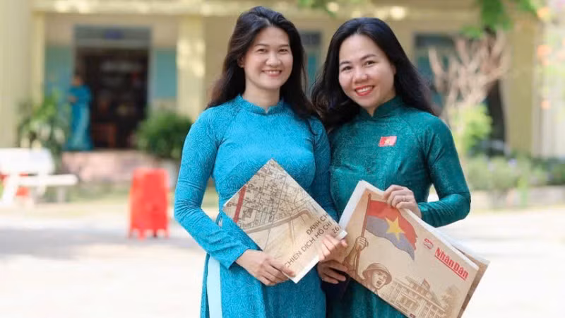 Giáo viên ở thành phố Biên Hòa hào hứng nhận phụ san của Báo Nhân Dân.