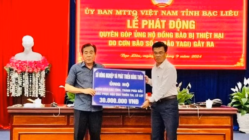 Giám đốc Sở Nông nghiệp và Phát triển nông thôn Bạc Liêu Lưu Hoàng Ly (bên trái) trao số tiền ủng hộ 30 triệu đồng.