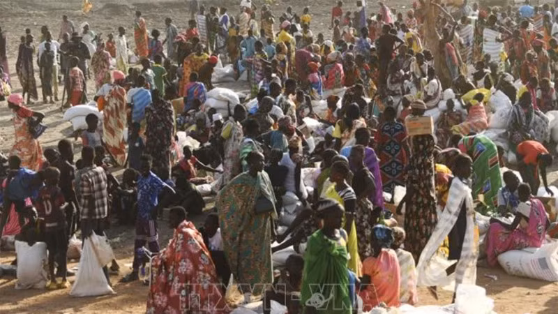 Người dân xếp hàng chờ nhận hàng cứu trợ tại Gedaref, Sudan. (Ảnh: AFP/TTXVN)