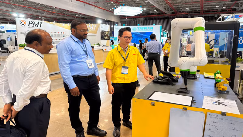 Khách tham quan một hệ thống máy gia công cơ khí chính xác tại triển lãm.