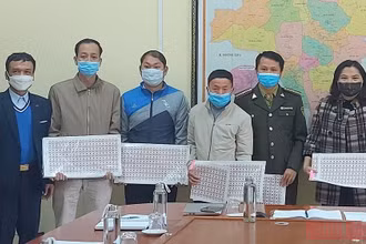 Cán bộ Chi cục tiêu chuẩn và đo lường chất lượng, Sở Khoa học-Công nghệ tỉnh Điện Biên, bàn giao tem truy xuất nguồn gốc cây đào cho huyện Tuần Giáo.