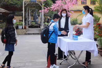 Giáo viên Trường tiểu học Ngô Sĩ Liên (TP Bắc Giang) hướng dẫn học sinh sát khuẩn tay trước khi vào lớp. (Ảnh: Lệ Thanh)