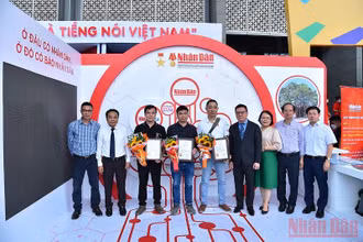 Đồng chí Lê Quốc Minh, Ủy viên Trung ương Đảng, Tổng Biên tập Báo Nhân Dân, Phó Trưởng Ban Tuyên giáo Trung ương, Chủ tịch Hội Nhà báo Việt Nam và Ban Chấp hành Liên Chi hội nhà báo Báo Nhân Dân với các tác giả có tác phẩm đạt giải. (Ảnh: THỦY NGUYÊN)