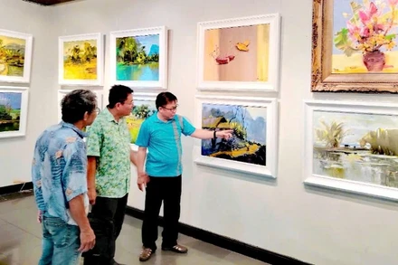 Họa sĩ Quỳnh Thơm (bên phải) trực tiếp chia sẻ về tác phẩm tại không gian triển lãm.