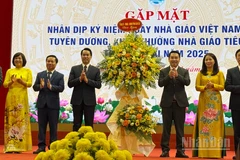 Lãnh đạo tỉnh Lào Cai tặng hoa chúc mừng Ngày nhà giáo Việt Nam. (Ảnh: THANH SƠN)