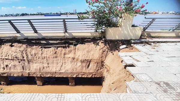 Sạt lở làm sụp vỉa hè, tạo thành một hố sâu.