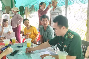 Cán bộ Biên phòng tuyên truyền, hướng dẫn ngư dân tiếp cận mô hình “Cẩm nang ngư dân số” thông qua quét mã QR, góp phần nâng cao nhận thức và chấp hành các quy định về chống khai thác IUU. (Ảnh: HÒA BÌNH)