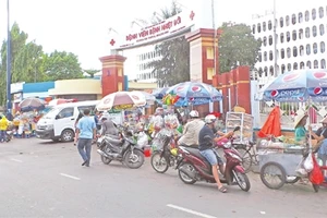 Cổng Bệnh viện Bệnh Nhiệt Đới trở thành chợ bán hàng rong, ảnh hưởng nghiêm trọng đến giao thông.