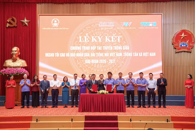 Đồng chí Nguyễn Huy Tiến, Viện trưởng Kiểm sát nhân dân tối cao và đồng chí Lê Quốc Minh, Tổng Biên tập Báo Nhân Dân thực hiện nghi thức ký kết giữa Viện Kiểm sát nhân dân tối cao với Báo Nhân Dân. (Ảnh: QUANG MINH)