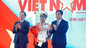 Chủ tịch Hội Nông dân Việt Nam Lương Quốc Đoàn (bên trái) và Phó Trưởng Ban Tuyên giáo và Dân vận Trung ương Phan Xuân Thủy trao giải Nhất cuộc thi viết "Việt Nam trong tôi".