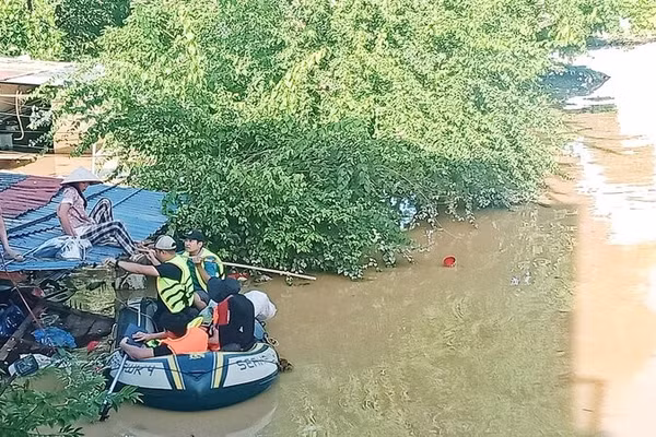 Lũ ngập đến mái nhà, lực lượng cứu hộ đón vợ anh Ngô Văn Hùng ở tổ 17, phường Phan Đình Phùng đến nơi an toàn. 
