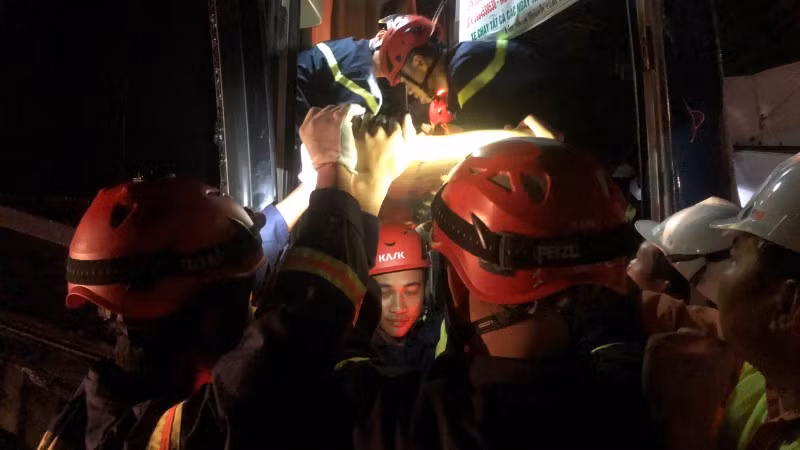 Lực lượng chức năng nỗ lực đưa nạn nhân ra khỏi cabin. (Ảnh: Công an cung cấp)