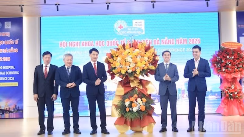 Thứ trưởng Y tế Trần Văn Thuấn tặng hoa chúc mừng Ban giám đốc Bệnh viện Đà Nẵng tổ chức thành công hội nghị. (Ảnh: ANH ĐÀO)