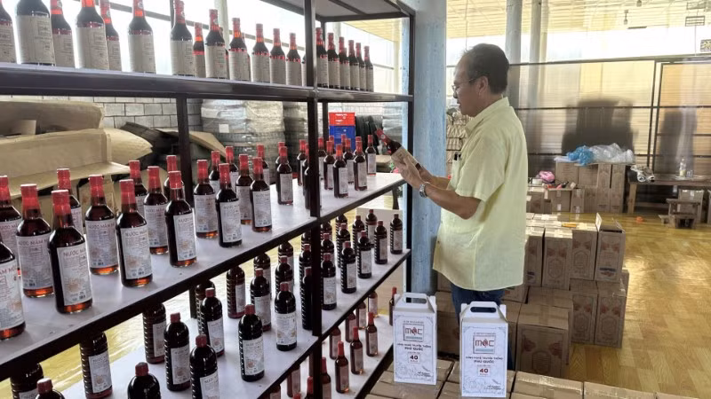  Anh Chu Quân với thành quả lao động-những chai nước mắm hoàn chỉnh mới “ra lò”.