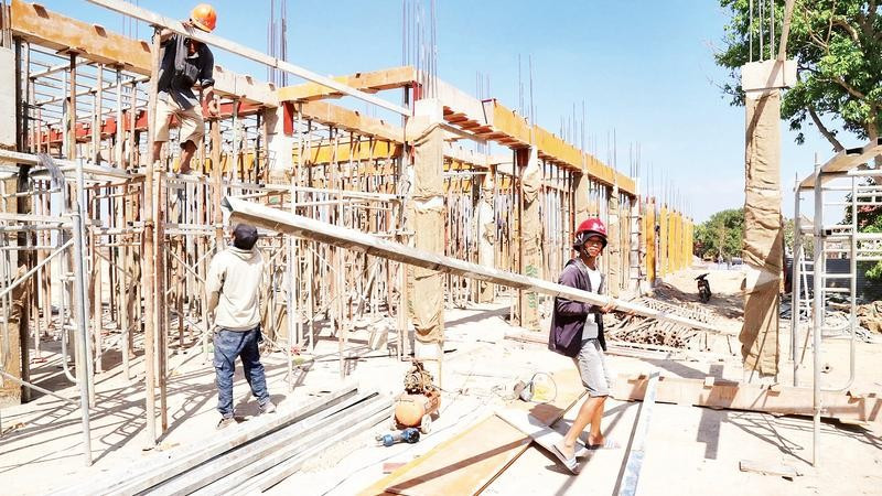 Các công nhân nỗ lực “vượt nắng thắng mưa” trên công trường xây dựng Trường phổ thông nội trú liên cấp tiểu học và trung học cơ sở xã Ia Lốp.