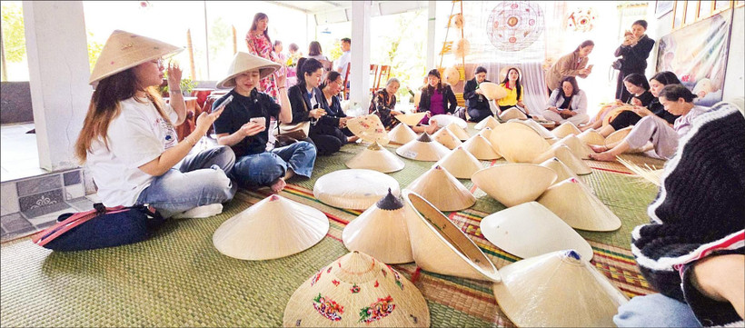 Du khách tham quan, tìm hiểu nghề làm nón ngựa Phú Gia.